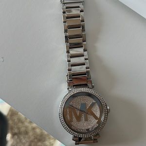 A big Michael Kors silver watch with diamonds